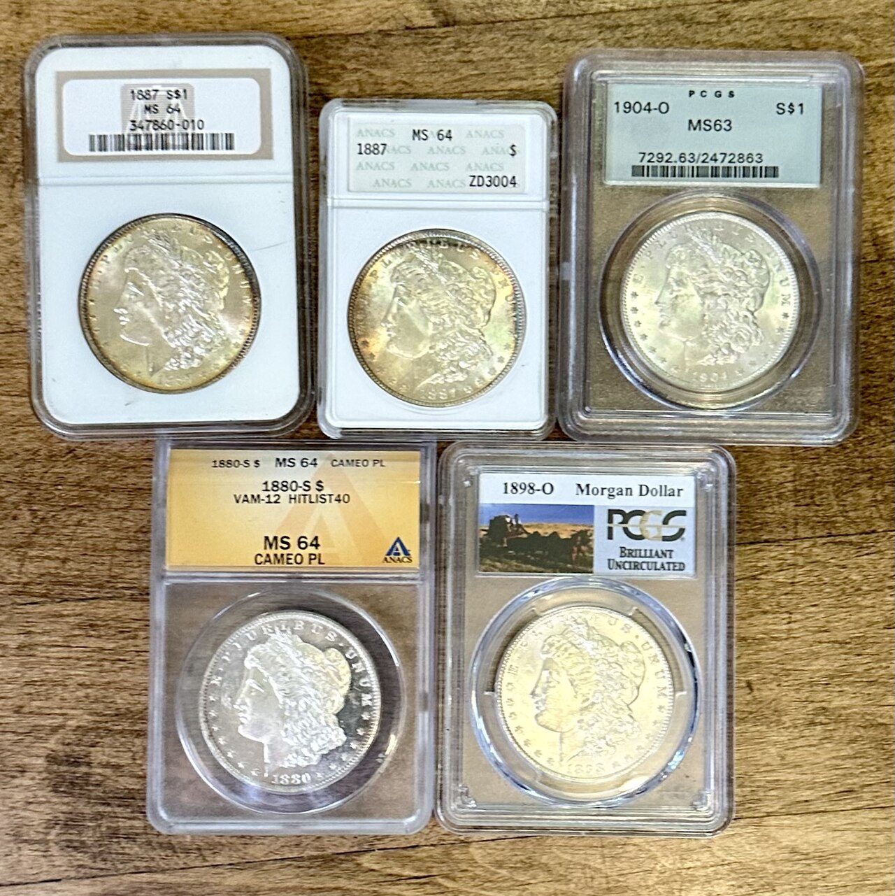 An assortment of NGC, PCGS, and ANACS certified coin holders