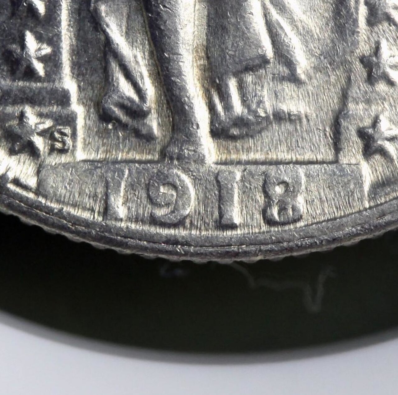 Close-up of the date on a 1918/7-S Standing Liberty quarter, with the 8 punched over a 7